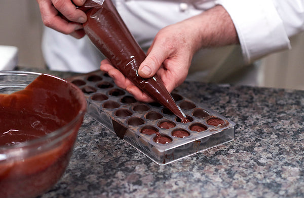 Jacques demonstrates filling the bonbon mold 
