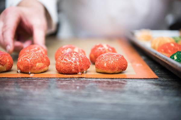 Tray of choux pastry balls waiting to be assembled